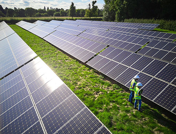 Image of two engineers inspecting solar panels.